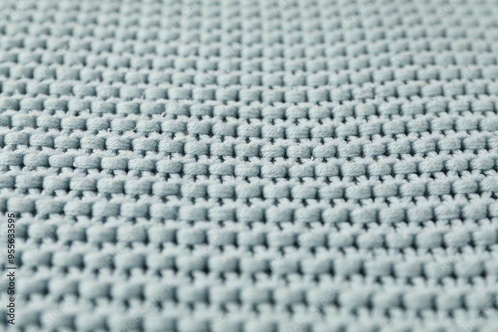 Naklejka premium Texture of light blue knitted fabric as background, closeup