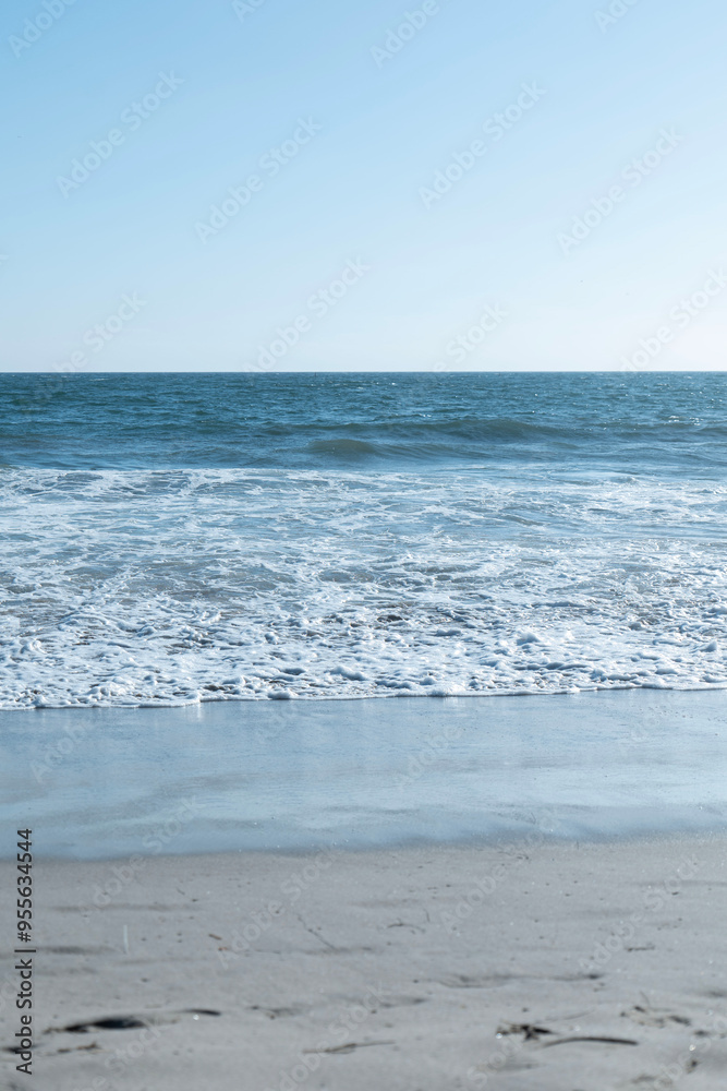 Ocean waves on the beach with a beautiful blue sky in Los Angeles Ocean waves on the beach with a beautiful blue sky in Los Angeles