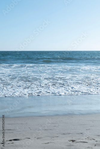 Ocean waves on the beach with a beautiful blue sky in Los Angeles