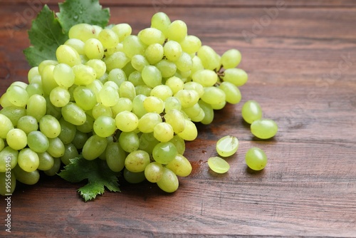 Delicious fresh ripe grapes on wooden table