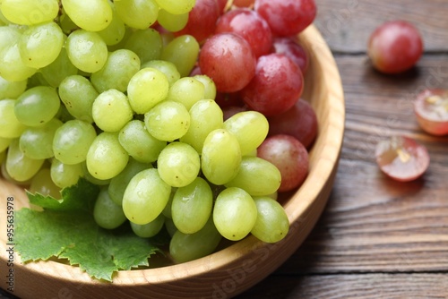 Fresh ripe grapes on wooden table, closeup