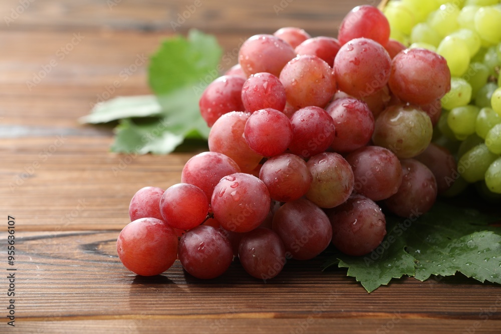 Fresh ripe grapes on wooden table, closeup Fresh ripe grapes on wooden table, closeup