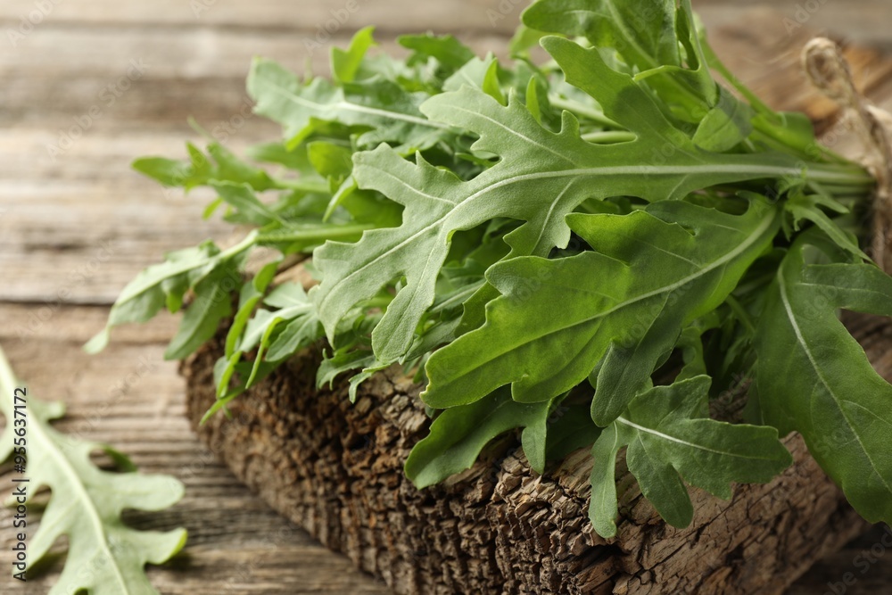 Bunch of fresh green arugula leaves on wooden table, closeup Bunch of fresh green arugula leaves on wooden table, closeup
