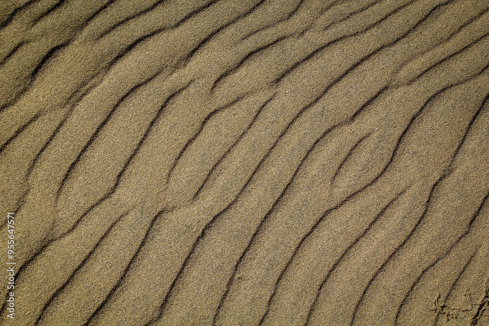 Eine durch Wind und Wellen entstandene Sandtextur am Strand.
Eine durch Wind und Wellen entstandene Sandtextur am Strand.