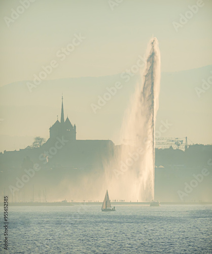 Sunset in Geneva with cathedral and sailing boat 