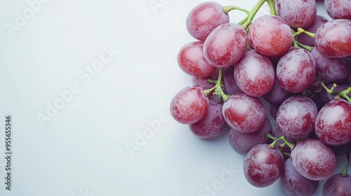 A cluster of fresh red grapes on a light background, showcasing their natural beauty. photo