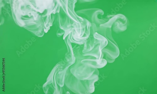 White vape smoke swirling and floating against a green screen background, perfect for video compositing and overlays.

