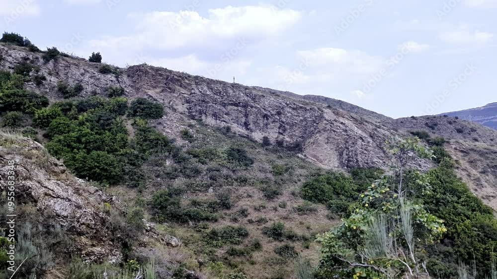 From here, you can enjoy a breathtaking view of the rugged mountain slopes covered in a variety of vegetation. The mountain landscape gives way to the landscape seen from the highway Mzcheta, Georgia. From here, you can enjoy a breathtaking view of the rugged mountain slopes covered in a variety of vegetation. The mountain landscape gives way to the landscape seen from the highway Mzcheta, Georgia.