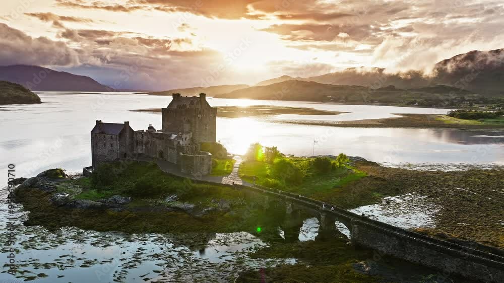 Aerial view of a rainbow over Eilean Donan Castle with long arched bridge and lochside setting. Scottish icon and a popular tourist attraction in the Highlands overlooking the Isle of Skye. Aerial view of a rainbow over Eilean Donan Castle with long arched bridge and lochside setting. Scottish icon and a popular tourist attraction in the Highlands overlooking the Isle of Skye.