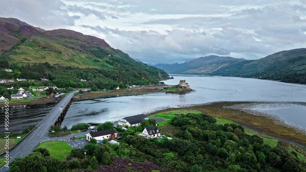 Aerial view of Scottish houses near Eilean Donan Castle in Scotland. Scottish icon and a popular tourist attraction in the Highlands overlooking the Isle of Skye. Aerial view of Scottish houses near Eilean Donan Castle in Scotland. Scottish icon and a popular tourist attraction in the Highlands overlooking the Isle of Skye.