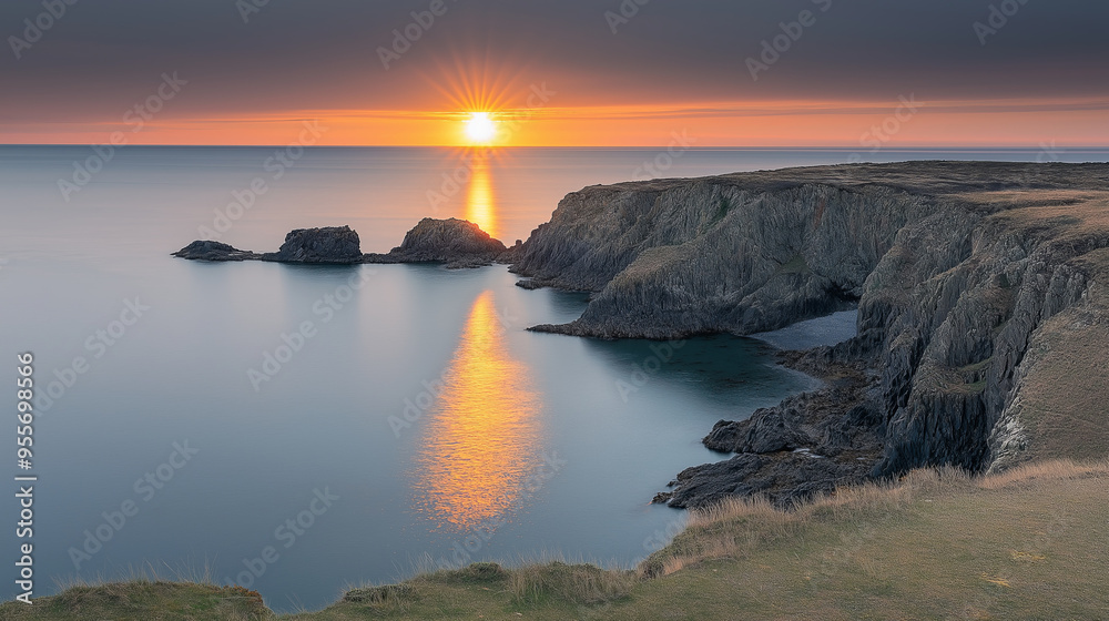 Dramatic sunset over a rugged coastline with golden reflections. Dramatic sunset over a rugged coastline with golden reflections.