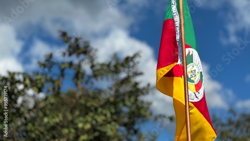 Flag of the State of Rio Grande do Sul waving in the wind on a nature background. Gaucho Flag. Week in the South of Brazil Farroupilha dos Gaúchos.