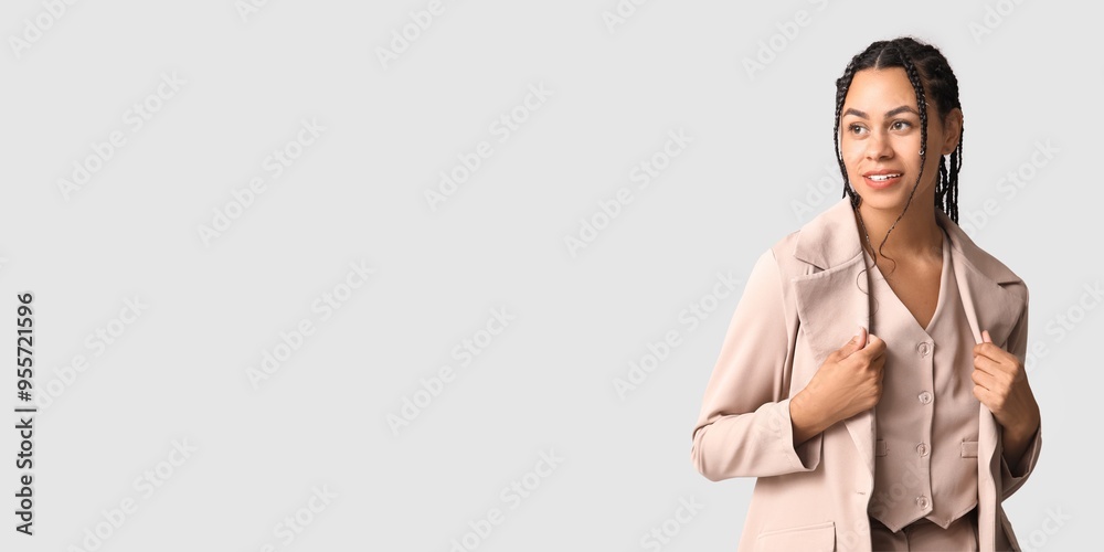 Stylish young African-American woman on light background with space for text Stylish young African-American woman on light background with space for text