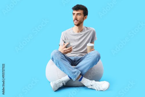 Handsome young man with cup...
