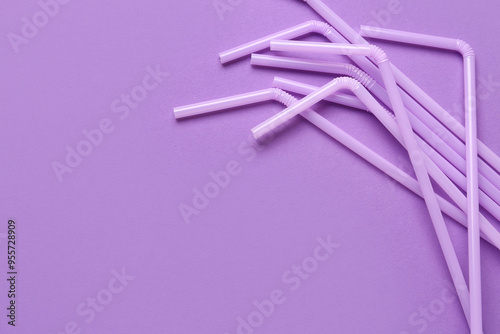 Lilac plastic straws on pur...
