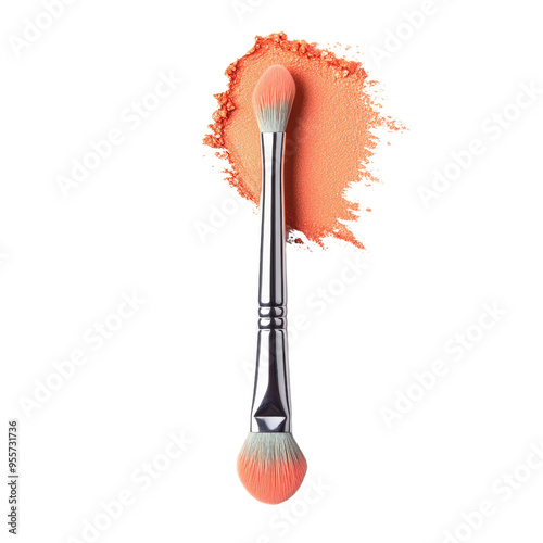 A makeup brush with a soft, peach-colored powder on the tip. The brush is made of silver metal. photo