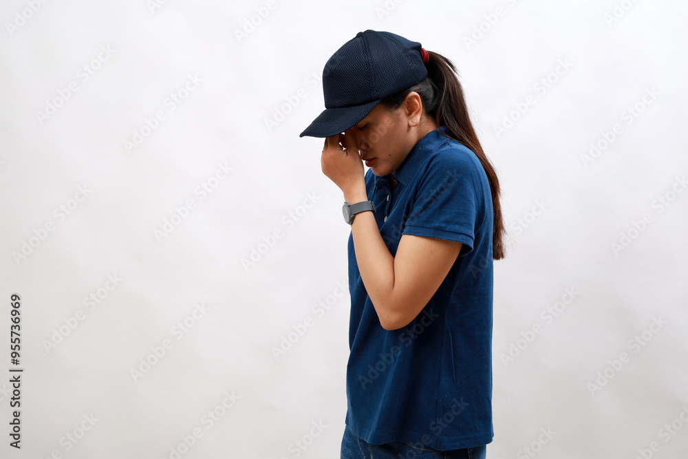 Young asian woman courier wearing delivery uniform and cap tired rubbing nose and eyes feeling fatigue and headache. stress and frustration concept. Young asian woman courier wearing delivery uniform and cap tired rubbing nose and eyes feeling fatigue and headache. stress and frustration concept.