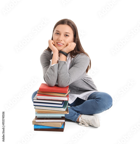 Female student with books sitting on white background