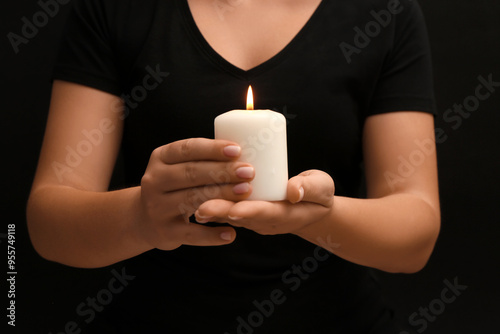 Person holding lit white ca...