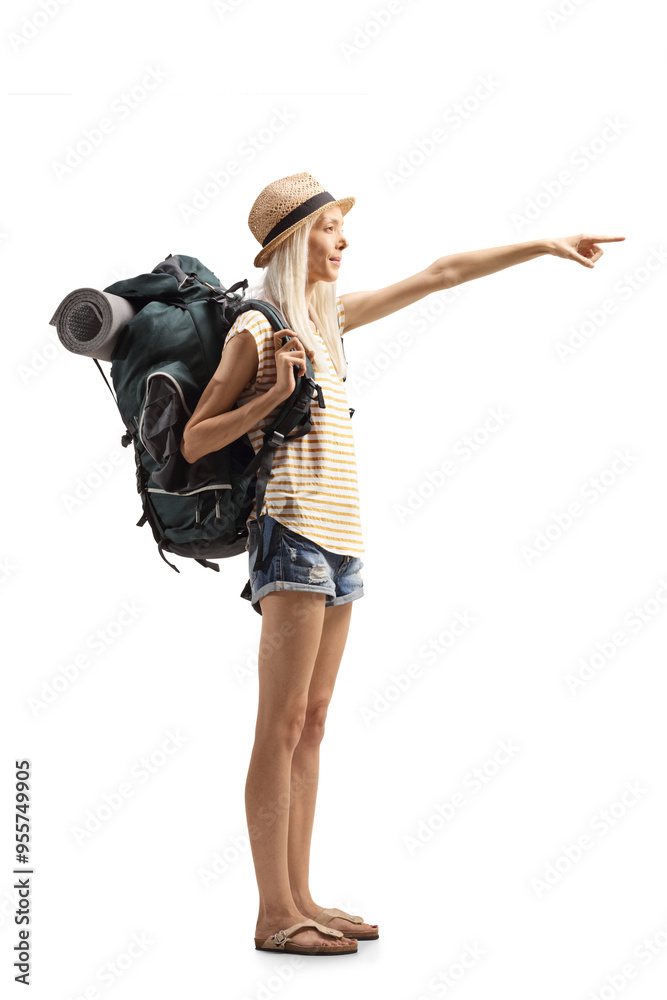 Full length shot of a female tourist with a backpack pointing Full length shot of a female tourist with a backpack pointing
