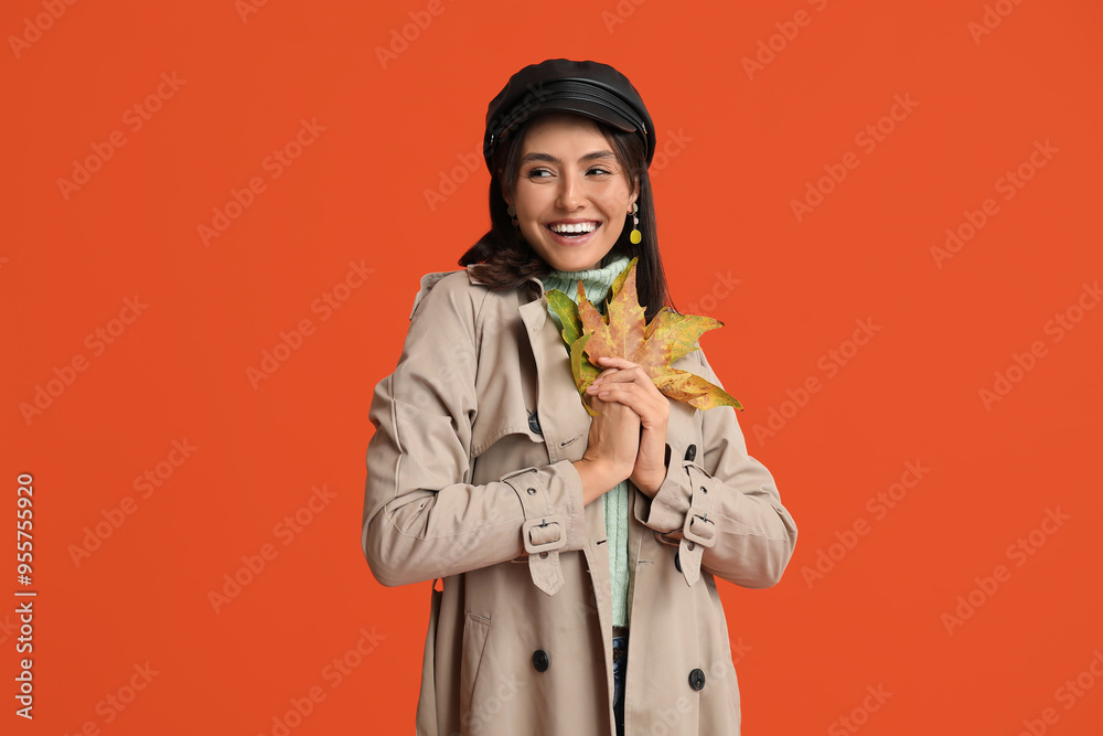 Beautiful young woman with autumn leaves on red background Beautiful young woman with autumn leaves on red background
