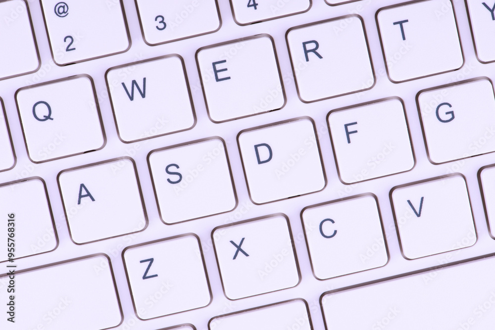 Close-up view of a white keyboard with black lettering on the keys. It could be relevant for topics related to technology, typing or computer hardware. Close-up view of a white keyboard with black lettering on the keys. It could be relevant for topics related to technology, typing or computer hardware.