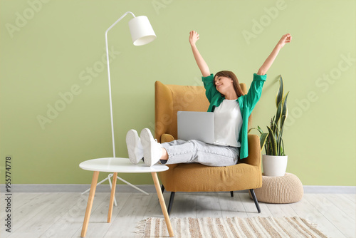 Happy young woman with lapt...