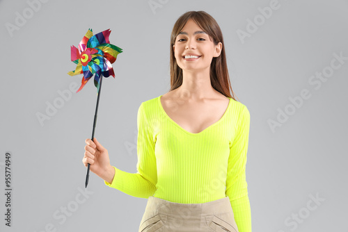 Young woman with toy windmi...