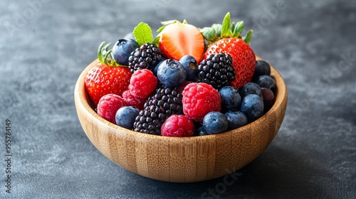 Assorted colorful berries in a wooden bowl, packed with antioxidants for brain health