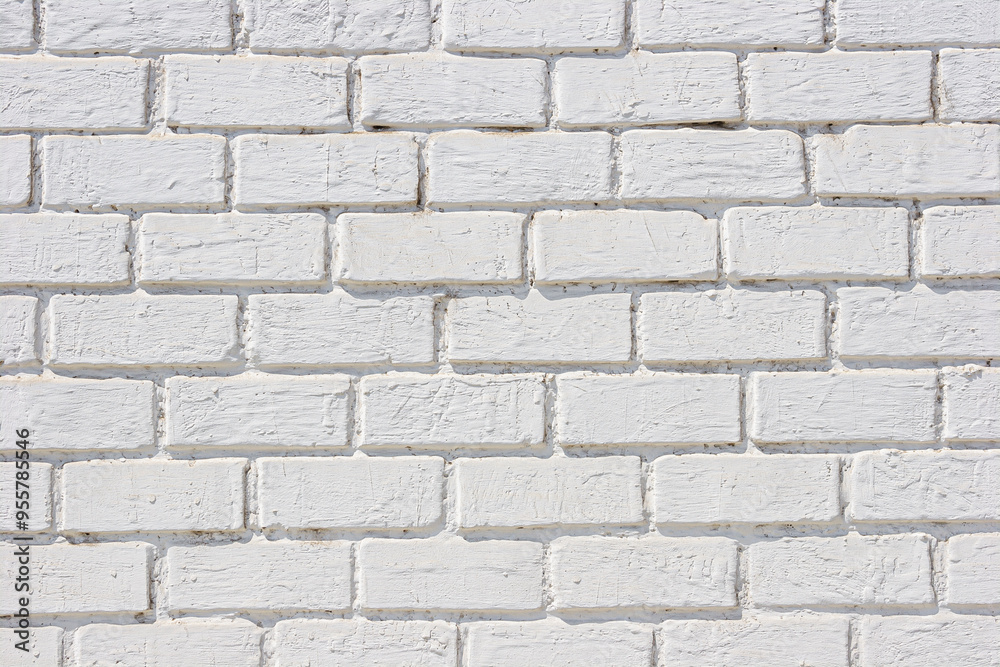 White brick wall texture with rough patches and wear. White brick wall texture with rough patches and wear.