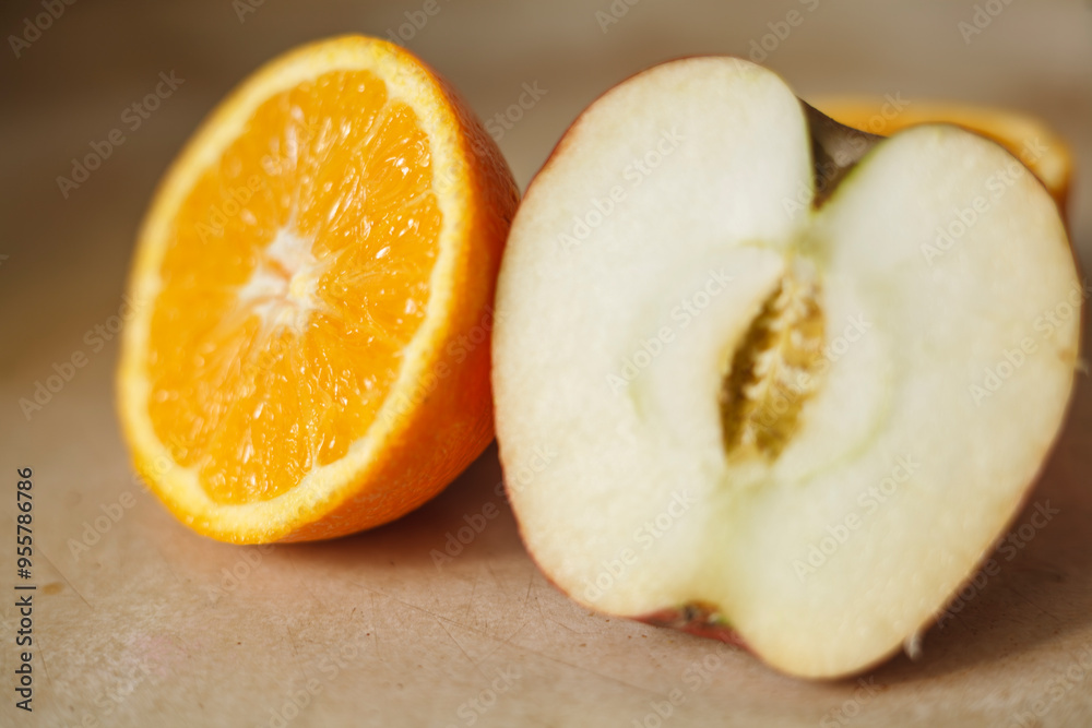 Incompatible Pair: Halved Orange and Apple Side by Side
