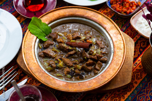 Mutancana, one of popular dishes of Ottoman Palace Cuisine from lamb with sweet dried fruits, honey and almonds photo