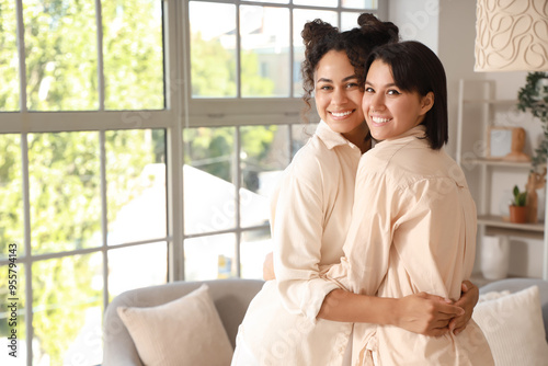Young lesbian couple huggin...