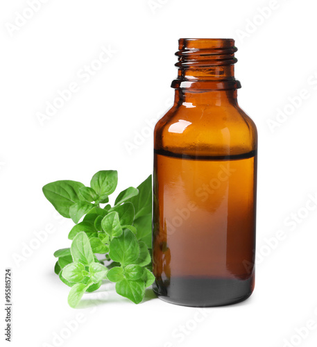 Essential oil in bottle and oregano leaves isolated on white