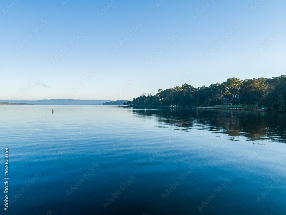 Still blue waters of coastal lake with buoy in water Still blue waters of coastal lake with buoy in water