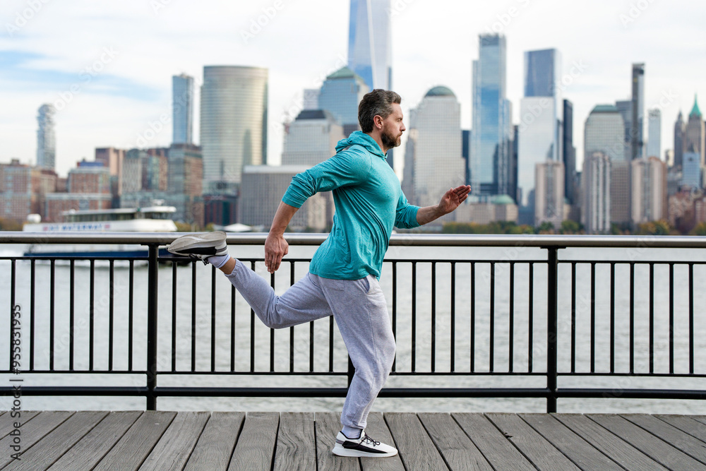 Run outdoor. Running man jogging outside in street. Mature man runner and fitness sport models training outdoor near Manhattan in New York. Millennial athlete jogging. Sports training outdoors.