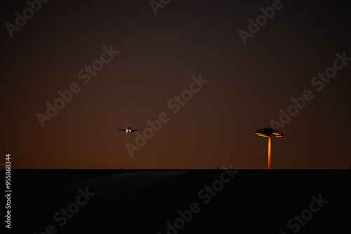 Airplane coming into land over Sydney Airport Domestic Terminal at night with lights on photo