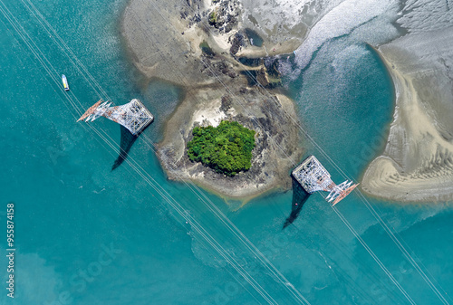 Aerial and top angle view of two transmission towers with high voltage lines on uninhabited islands at Yeongheungdo Island near Ongjin-gun, South Korea photo