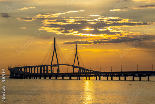 Songdo, Yeonsu-gu, Incheon, South Korea - July 17, 2021: Sunset view of Incheon Bridge on the sea against sea horizon in summer photo