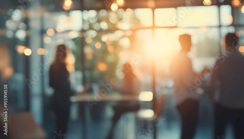 Blurred silhouettes of people in a cafe with warm lighting