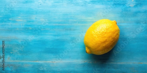 Bright yellow lemon on soft blue vintage background, lemon, yellow, fruit, citrus, fresh, vibrant, colorful, food, healthy