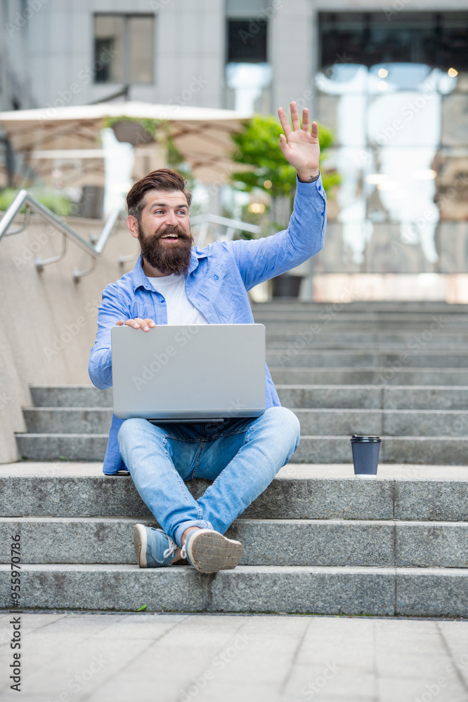 man freelancer has video call at coffee break. waving hello. man freelancer has video call man freelancer has video call at coffee break. waving hello. man freelancer has video call