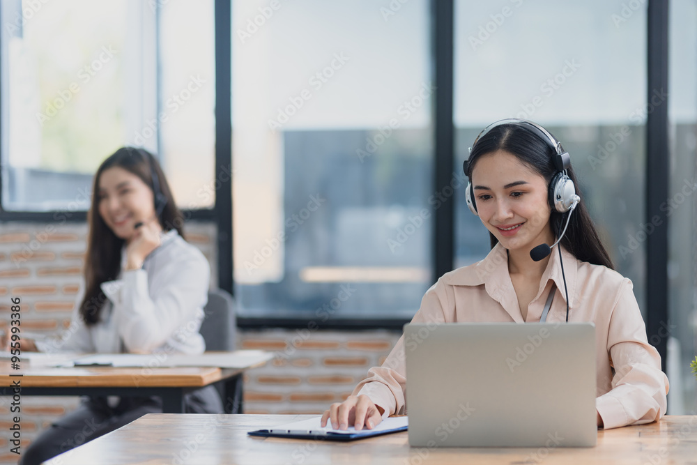 Young asian businesswoman with headset using desktop computer for customer support and online working in office, Call center helping for customers online concept.