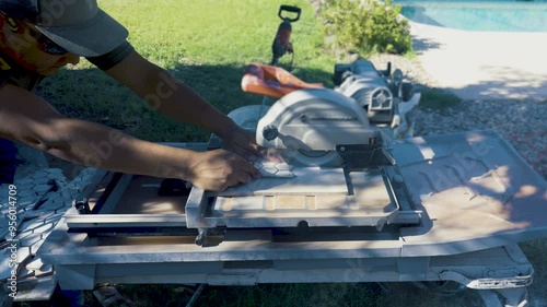 Tiler cutting the tile with a circular saw. The perfect tile-cutting blade for a circular saw when cutting porcelain tile is the diamond blade.