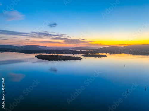 Sunrise along the waterfront with reflections on the bay water