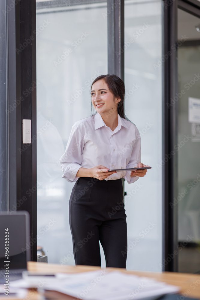 Happy confident asian professional business woman standing at work in office arms crossed looking away, asian businesswoman leader executive thinking of future success. Happy confident asian professional business woman standing at work in office arms crossed looking away, asian businesswoman leader executive thinking of future success.