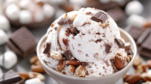 A delicious scoop of Rocky Road ice cream, brimming with marshmallows, nuts, and chocolate chunks, ready to be enjoyed