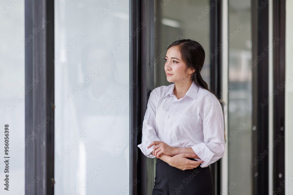 Happy confident asian professional business woman standing at work in office arms crossed looking away, asian businesswoman leader executive thinking of future success. Happy confident asian professional business woman standing at work in office arms crossed looking away, asian businesswoman leader executive thinking of future success.