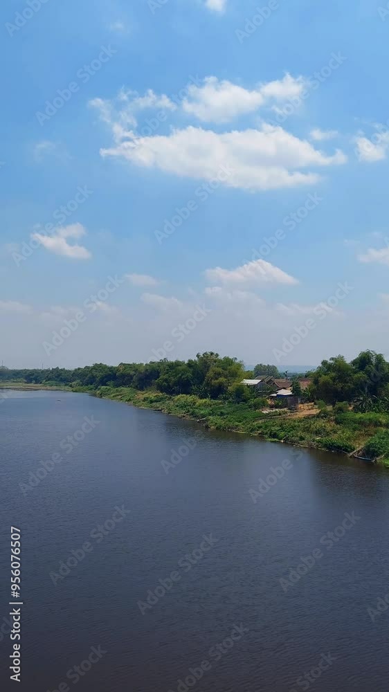 The flow of the Bengawan River during the day in Padangan Bojonegoro, Indonesia The flow of the Bengawan River during the day in Padangan Bojonegoro, Indonesia