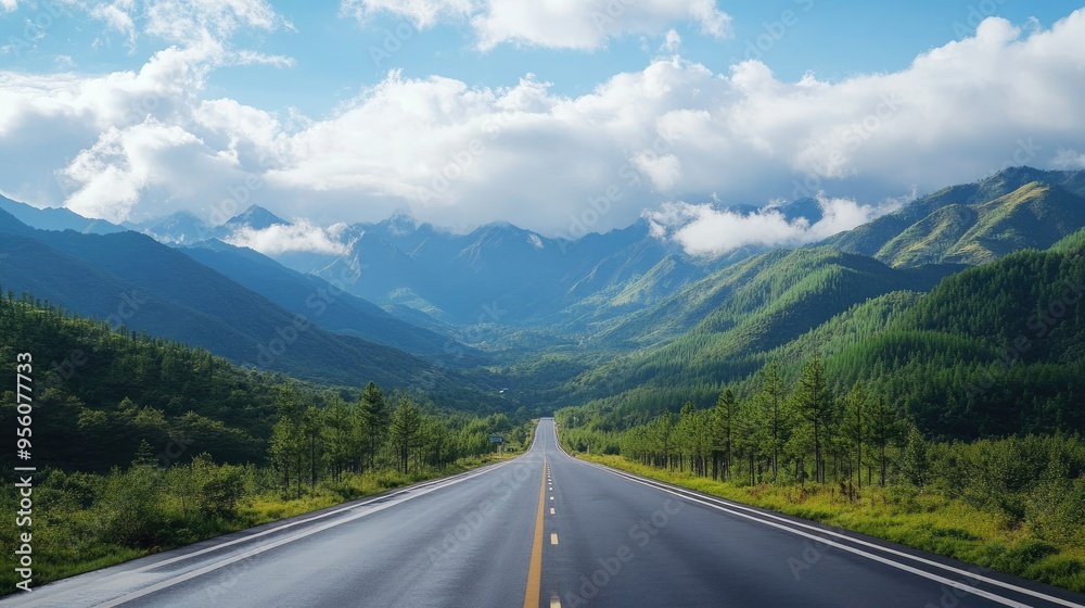 Long highway road surrounded by green mountains, with a peaceful morning sky filled with clouds Long highway road surrounded by green mountains, with a peaceful morning sky filled with clouds